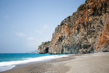 Fototapeta premium Mediterranean beach with turqouise sea and rocks on shore