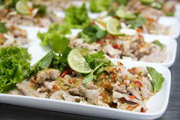  Spicy  pork salad with dried chili and garnished with mint.