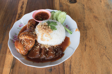 Close up thai sweet braised chicken with sesame on rice.