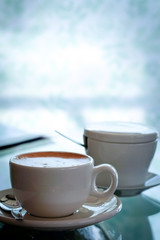 Cup of coffee on the table mirrors The atmosphere is relaxed and comfortable, Cool tone.