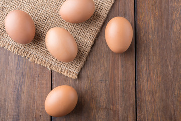 Fresh eggs on wood background. Top view