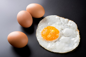 fried eggs on black background, egg