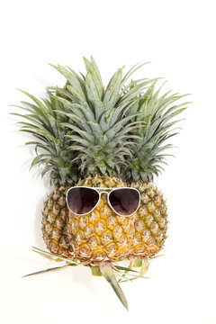 pineapple with sunglasses on white background.