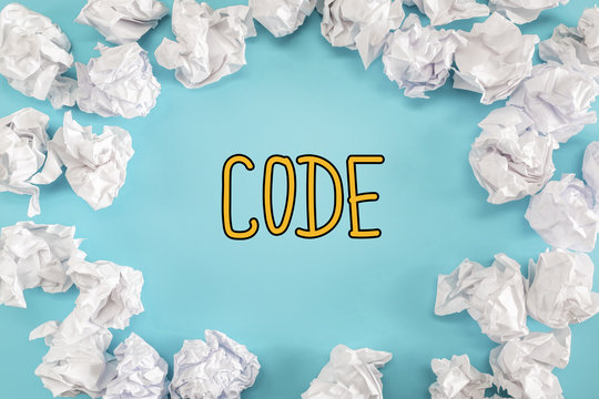 Code text with crumpled paper balls