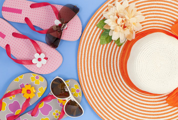 beach shoes with sunglasses and hat on blue background,Summer holiday concept.