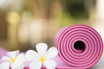 pink yoga mat and a flowers