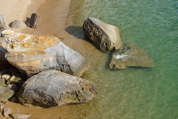 Fototapeta na wymiar rocks on a sandy beach. Thailand 2017