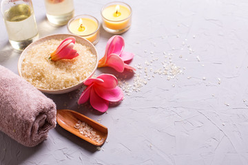 Sea salt in bowl, candles, towel and flowers