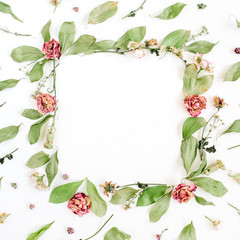 Fototapeta premium Round frame wreath pattern with roses, pink flower buds, branches and leaves on white background. Flat lay, top view. Flowers pattern