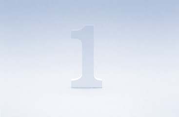 Number one on blue background. Top concept. Wooden number1 as symbol of success.