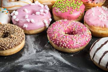 glazed donuts with different fillings on a black background
