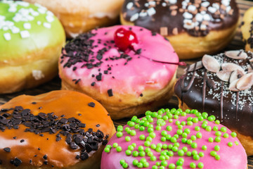 glazed donuts with different fillings on a blue wooden table