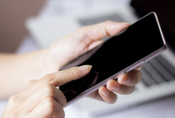 Hand holding mobile smartphone with blank screen