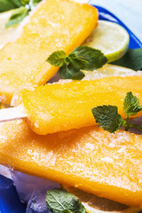 popsicle of orange and peach and mint on a table