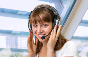 Call centre operator with headset at workplace in call center