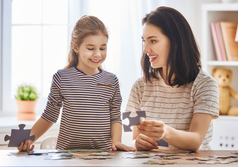 Mother and daughter do puzzles
