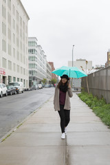 Asian Woman Holding Umbrella While Raining