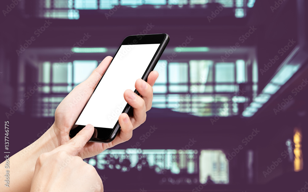 Poster Hand click mobile phone with blur office corridor hall way background bokeh light,White screen mock up template for adding your design or your text