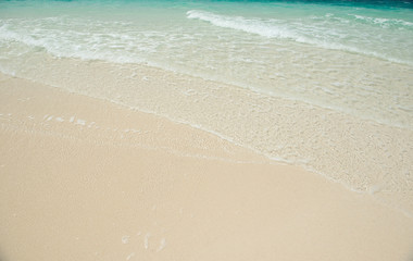 Fototapeta na wymiar sandy beach and clear transparent sea wave