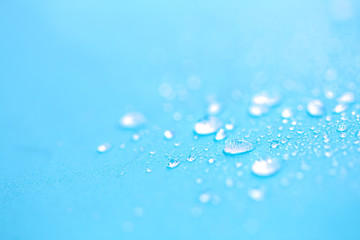 Close up rain water drops on blue sponge surface as abstract background