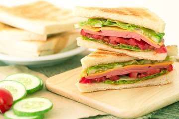Sliced Grilled sandwiches bread with bacon , ham and cheese with vegetable , healthy breakfast
