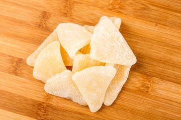 Organic gummy grapefruit slices isolated on a wood background
