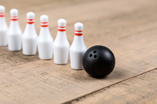 Toy Bowling Ball And Pins Isolated On A Wood Background