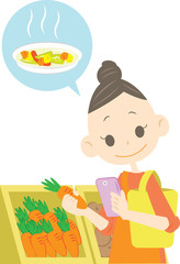 スマホを見ながら買い物するママ