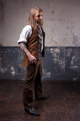 Handsome male Steam punk. Retro man portrait over grunge background.