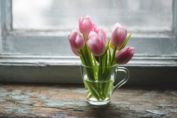 Tulips on the wooden background