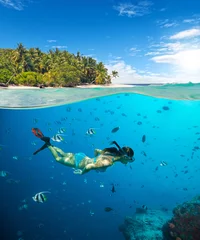 Tuinposter Young woman snorkeling on tropical beach © Jag_cz