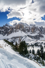 Fototapeta na wymiar Cloudy view of snow valley near Canazei of Val di Fassa, Trentino-Alto-Adige region, Italy.