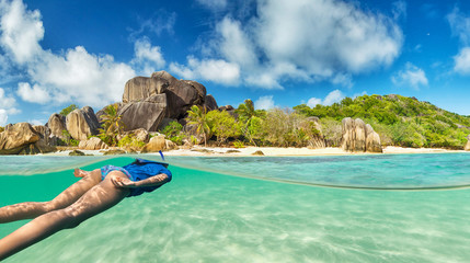 Fototapeta na wymiar Young woman snorkeling on tropical beach