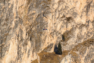 Paratrooper at the background of Dolomite Alps near Canazei of Val di Fassa, Trentino-Alto-Adige region, Italy.