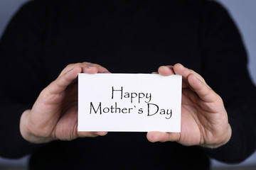 man holding card congratulating women on Mother's Day