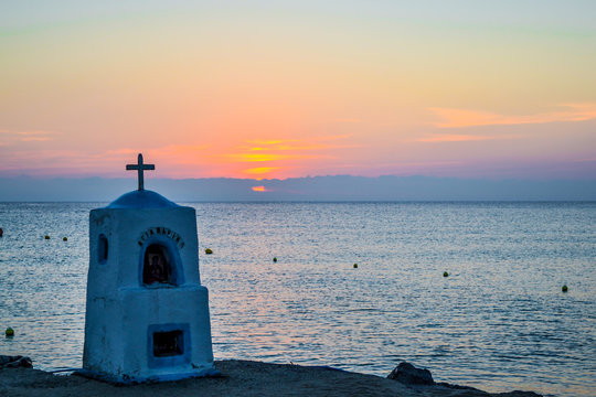 Agia marina monument drowned by the sea at sunset. Greece.