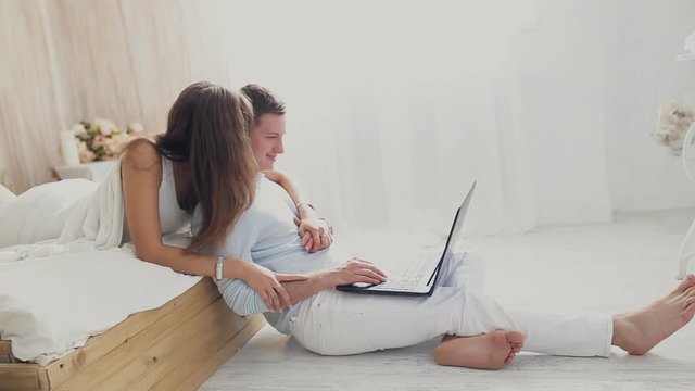 loving couple with laptop at home