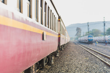 Passenger train of Thai Railways. The nearest purple car is in the focus, other things dissolve into nice bokeh. This is a second class sitting car of a train Ubon Ratchathani - Bangkok (Thailand)