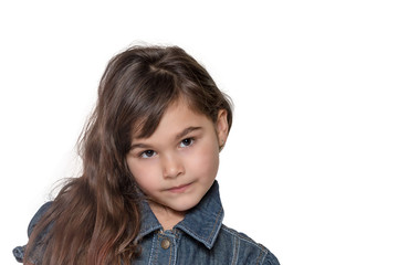 Portrait of long haired brunette little girl isolated on the white background. Girl is looking at the camera. 