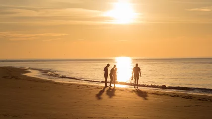 Poster Groep mensen op het strand van Ameland tijdens zonsondergang © Leandervasse