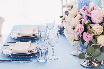 Beautiful decorated table set for wedding party. Wedding decorations with flowers