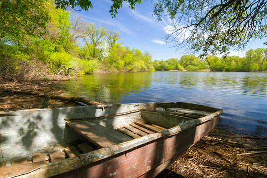Wooden boat near the big lake in marshes ("plavni") of Khortytsia island in spring, Zaporozhye, Ukraine