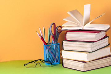 Open book, hardback bookson bright colorful background.