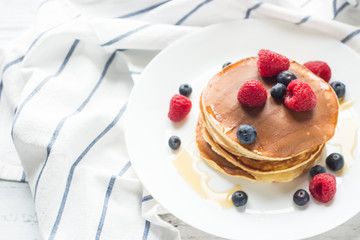 Breakfast. Berries. Pancakes. Romantic breakfast on a wooden table. Spring morning. Cozy.