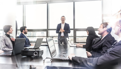 Successful team leader and business owner leading informal in-house business meeting. Business...