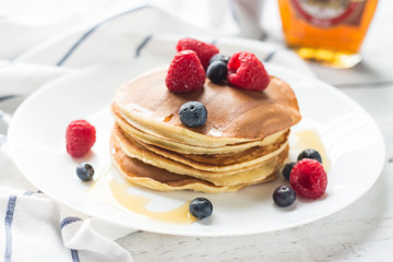 Breakfast. Berries. Pancakes. Romantic breakfast on a wooden table. Spring morning. Cozy.
