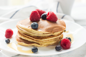 Breakfast. Berries. Pancakes. Romantic breakfast on a wooden table. Spring morning. Cozy.