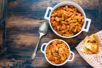 Fusilli pasta with chicken. Cooked in spicy sauce from tomatoes, onion, garlic, dried oregano and thyme, paprika and olive oil.Top view.