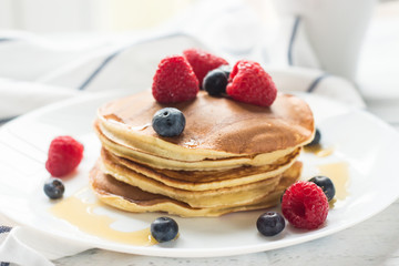 Breakfast. Berries. Pancakes. Romantic breakfast on a wooden table. Spring morning. Cozy.