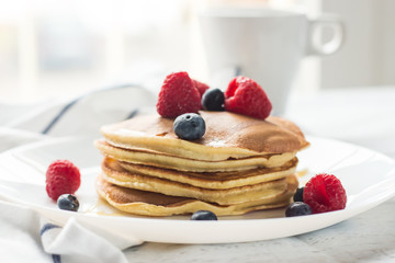 Breakfast. Berries. Pancakes. Romantic breakfast on a wooden table. Spring morning. Cozy.
